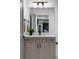 Modern bathroom vanity with wood-tone cabinets, quartz countertop, and stylish fixtures at 1665 S Fillmore St, Denver, CO 80210