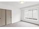 Bright bedroom with a large window, carpet floors, and sliding closet doors at 1665 S Fillmore St, Denver, CO 80210