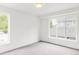 Bedroom featuring neutral carpeting and lots of natural light from the two large windows at 1665 S Fillmore St, Denver, CO 80210