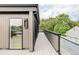 Long outdoor deck with glass railings provides panoramic views of mature trees at 1665 S Fillmore St, Denver, CO 80210