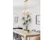 Bright dining room with modern light fixture, wood table, seating for six at 1665 S Fillmore St, Denver, CO 80210
