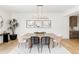 Bright dining room with modern light fixture, wood table, and views of the backyard at 1665 S Fillmore St, Denver, CO 80210