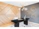 Modern office features geometric wood wall, gray walls, unique light fixture, and marble patterned rug at 1665 S Fillmore St, Denver, CO 80210