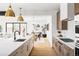 Open-concept kitchen featuring a large island, stainless steel appliances, and seamlessly connected dining area at 1665 S Fillmore St, Denver, CO 80210