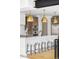 Kitchen island with marble countertop, pendant lighting, black faucet and seating at 1665 S Fillmore St, Denver, CO 80210
