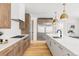 Modern kitchen with wood cabinets, white countertops, stainless steel appliances, and hardwood floors at 1665 S Fillmore St, Denver, CO 80210
