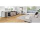 Bright living room with hardwood floors, a modern wet bar and comfortable seating at 1665 S Fillmore St, Denver, CO 80210