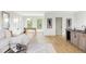 Open-concept living room with hardwood floors, wet bar, and comfortable sofa at 1665 S Fillmore St, Denver, CO 80210