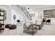 Bright, modern living room with stylish seating and an open staircase design at 1665 S Fillmore St, Denver, CO 80210
