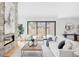 Bright living room with fireplace, modern furniture, and sliding glass doors to the backyard at 1665 S Fillmore St, Denver, CO 80210