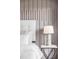 Close up of the main bedroom highlighting the paneled wall and side table decor at 1665 S Fillmore St, Denver, CO 80210