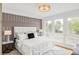 Main bedroom with paneled wall, neutral palette, large windows providing ample natural light at 1665 S Fillmore St, Denver, CO 80210