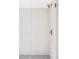 Modern shower featuring neutral tile, gray pebble floor and brushed gold hardware at 1665 S Fillmore St, Denver, CO 80210