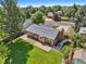 Aerial view of a well-maintained home featuring a spacious backyard, patio, and lush landscaping at 215 Sunland St, Louisville, CO 80027