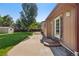 View of backyard with lush green lawn, storage shed, patio, and home's exterior at 215 Sunland St, Louisville, CO 80027