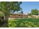 Backyard view showing spacious green lawn and the home's exterior at 215 Sunland St, Louisville, CO 80027
