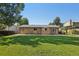 The backyard has a spacious green lawn perfect for outdoor activities and relaxation at 215 Sunland St, Louisville, CO 80027