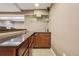 Close up of basement bar with wood cabinets, countertop, shelves and glassware at 215 Sunland St, Louisville, CO 80027