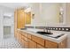 Well lit bathroom featuring a double sink vanity, granite countertops, black and white tiles at 215 Sunland St, Louisville, CO 80027