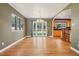 Bright dining area featuring hardwood floors with kitchen and backyard views at 215 Sunland St, Louisville, CO 80027