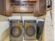 Efficient laundry room features modern machines, functional cabinets, and organized storage solutions for convenience at 215 Sunland St, Louisville, CO 80027
