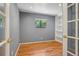 Office featuring gray walls, hardwood floors, a built in bookcase and a window with natural light at 215 Sunland St, Louisville, CO 80027