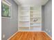 Office featuring a built-in bookcase with shelving, hardwood floors and natural light at 215 Sunland St, Louisville, CO 80027