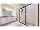 Modern bathroom with white subway tile shower, dual vanity, and patterned tile floors at 11916 Peakview Ln, Broomfield, CO 80021