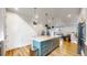 Spacious kitchen island with a white countertop, complemented by stylish lighting at 11916 Peakview Ln, Broomfield, CO 80021