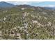 Stunning aerial view of a home and property in a wooded setting, offering privacy and views at 31911 Warrens Rd, Golden, CO 80403