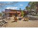 Inviting backyard seating area with a fire pit, wood chairs, and a multi-level deck overlooking stunning mountain views at 31911 Warrens Rd, Golden, CO 80403
