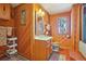Rustic bathroom featuring wood paneling, a unique window, and a traditional-style vanity at 31911 Warrens Rd, Golden, CO 80403