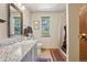Well-lit bathroom showcasing a granite countertop vanity, a toilet, shower, and natural light from a window at 31911 Warrens Rd, Golden, CO 80403