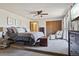 Cozy bedroom with a comfortable bed, ceiling fan, closet, and chair, creating a relaxing retreat at 31911 Warrens Rd, Golden, CO 80403