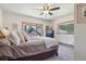 Bright bedroom features a large bay window, plush bed, and stylish dresser, offering tranquil views and comfort at 31911 Warrens Rd, Golden, CO 80403