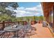 Spacious outdoor deck with seating, a table, and an outdoor grill, perfect for enjoying the views at 31911 Warrens Rd, Golden, CO 80403