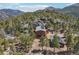 Scenic mountain home surrounded by trees featuring wood construction, solar panels, and a cozy guesthouse at 31911 Warrens Rd, Golden, CO 80403