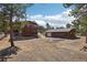 Charming two-story home with a detached garage, complemented by beautiful natural surroundings and a gravel driveway at 31911 Warrens Rd, Golden, CO 80403