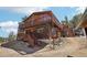 Charming multi-story home with wood siding, a spacious deck, and picturesque mountain views from the hillside at 31911 Warrens Rd, Golden, CO 80403