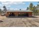 Open detached garage with three bays showing multiple garage doors and workspace, offering ample storage and convenience at 31911 Warrens Rd, Golden, CO 80403