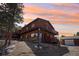 Charming home exterior with large deck, stone accents, and a detached garage on a sloped lot at 31911 Warrens Rd, Golden, CO 80403