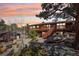 Beautiful home exterior with spacious decks, fire pit, and wooded surroundings perfect for outdoor living at 31911 Warrens Rd, Golden, CO 80403