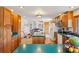 Bright kitchen offers wood cabinets, green countertops, and island with cooktop at 31911 Warrens Rd, Golden, CO 80403