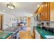Bright kitchen features wood cabinets, green countertops, and a center island with cooktop at 31911 Warrens Rd, Golden, CO 80403