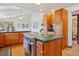 Spacious kitchen boasts wood cabinets and green countertops; cooktop on kitchen island at 31911 Warrens Rd, Golden, CO 80403