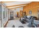 Open-concept living room with wood paneling, vaulted ceilings, comfortable seating, and ample natural light at 31911 Warrens Rd, Golden, CO 80403