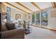 Bright living room with vaulted ceilings, exposed beams, large windows, and cozy seating for a relaxing atmosphere at 31911 Warrens Rd, Golden, CO 80403