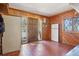Functional mud room with wood paneling, tile flooring, and a convenient Tesla power wall at 31911 Warrens Rd, Golden, CO 80403