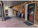 Inviting covered patio with chairs and neatly stacked firewood, blending comfort with practicality at 31911 Warrens Rd, Golden, CO 80403