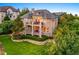 Spacious backyard featuring a large deck, stone accents, and lush landscaping at 1222 Buffalo Ridge Rd, Castle Pines, CO 80108